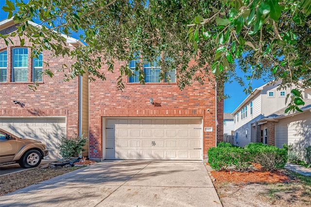 view of front of property with brick siding, concrete driveway, and a garage