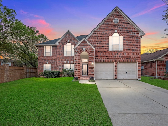 view of front of property featuring brick siding, concrete driveway, a front yard, and fence