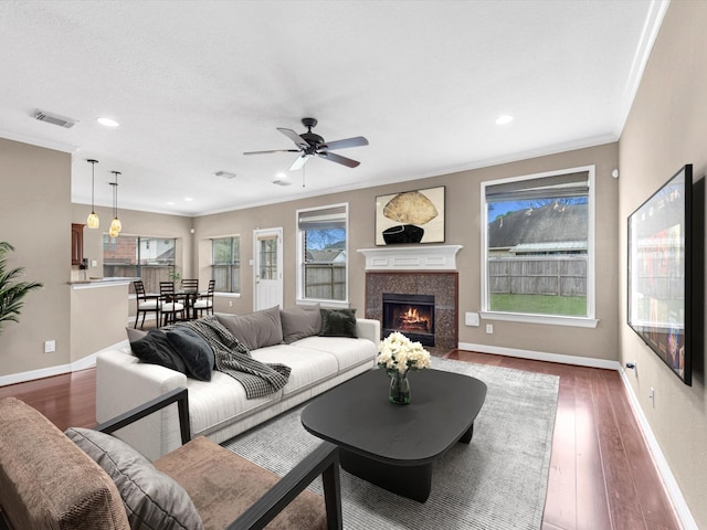 living room featuring baseboards, dark wood-style floors, and crown molding