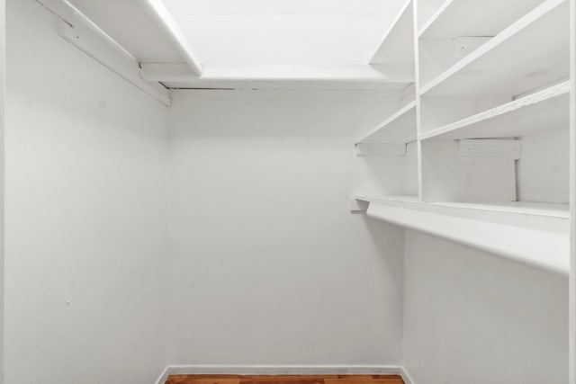 spacious closet with wood finished floors