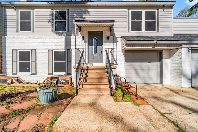 view of front of property with brick siding, an attached garage, and concrete driveway