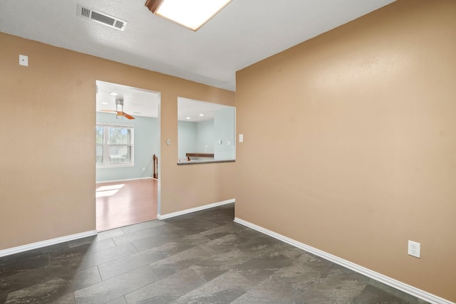 unfurnished room with visible vents and baseboards