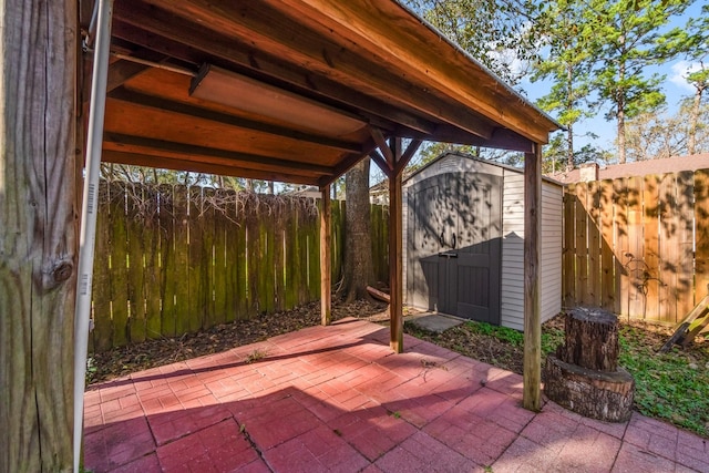 view of patio / terrace with a storage unit, an outdoor structure, and a fenced backyard