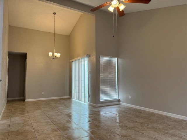 unfurnished room featuring light tile patterned floors, baseboards, and ceiling fan with notable chandelier