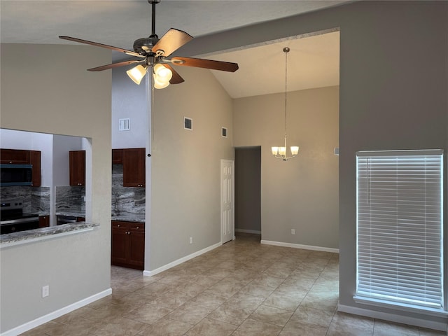 unfurnished living room featuring visible vents, ceiling fan with notable chandelier, baseboards, and vaulted ceiling