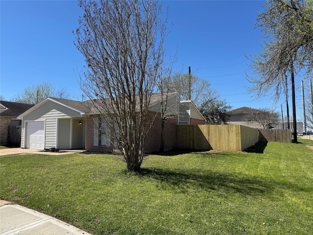 view of front of home with a garage, concrete driveway, a front lawn, and fence