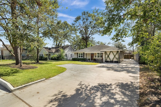 view of front facade with fence, concrete driveway, a front yard, and a gate