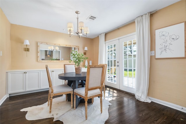 dining area featuring visible vents, baseboards, french doors, an inviting chandelier, and dark wood-style flooring