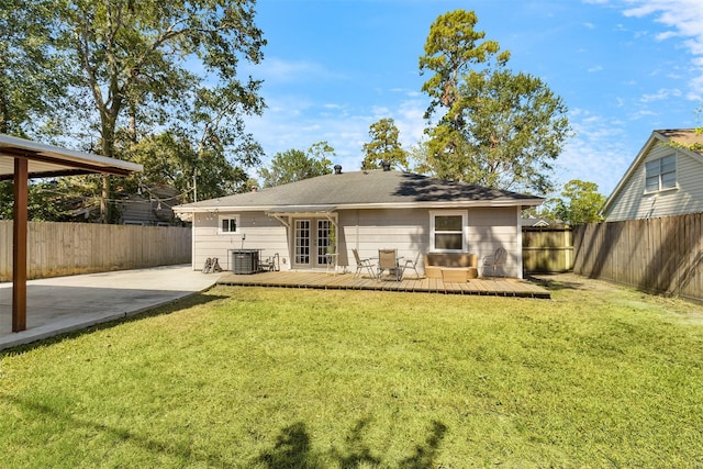 back of house with a yard, central air condition unit, a wooden deck, and a fenced backyard