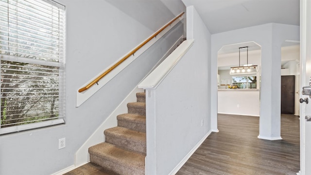 stairway featuring baseboards and wood finished floors