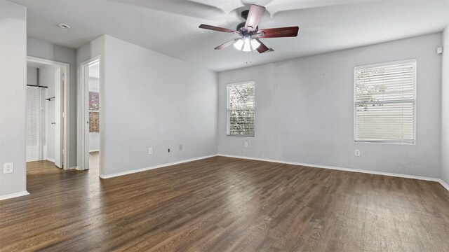 empty room with ceiling fan, baseboards, and wood finished floors