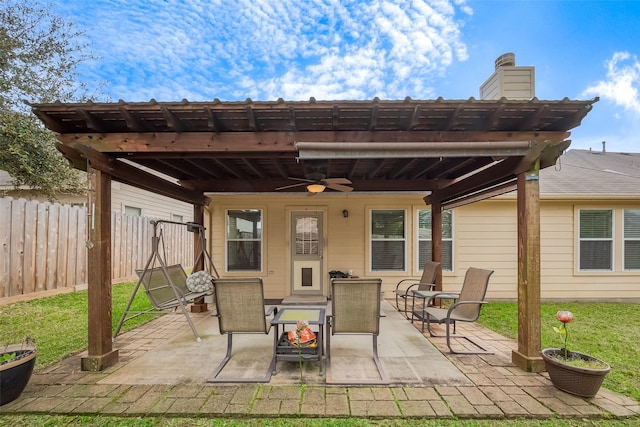 view of patio / terrace with a ceiling fan and fence