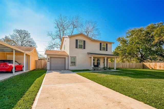traditional home with a front yard, an attached garage, fence, and concrete driveway