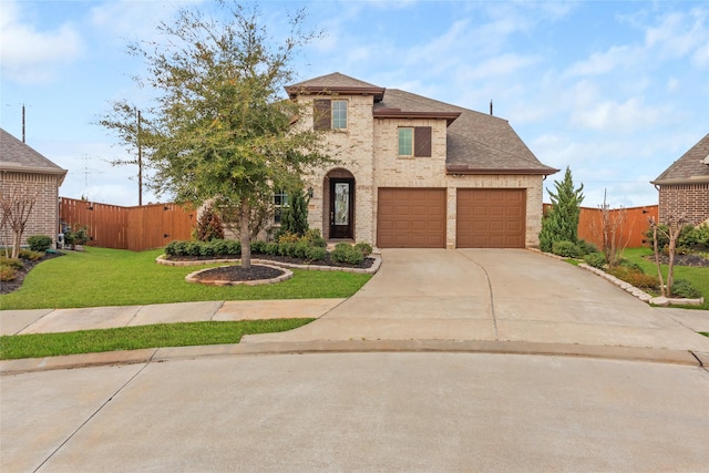 view of front facade with a front lawn, fence, brick siding, and driveway