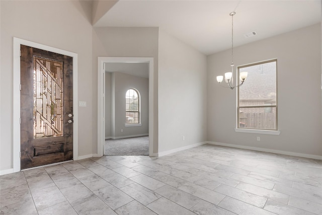 interior space with visible vents, baseboards, and an inviting chandelier