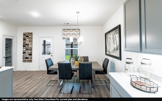 5111 Magnolia Springs Dr, Pearland, TX 77584 - dining space with visible vents, wood finished floors, and a chandelier