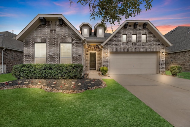 view of front of property featuring roof with shingles, concrete driveway, a front yard, an attached garage, and brick siding