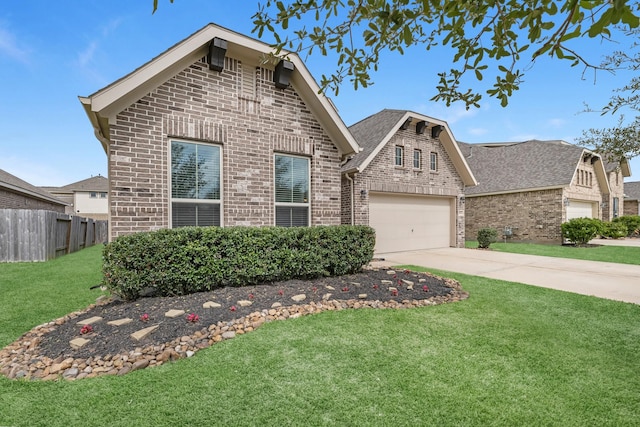 view of front of home with brick siding, fence, a front yard, a garage, and driveway