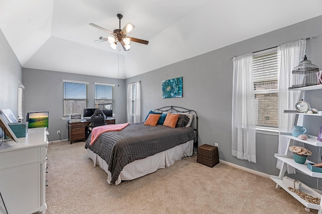 bedroom featuring lofted ceiling, a ceiling fan, baseboards, and light carpet