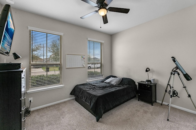 bedroom with a ceiling fan, carpet, and baseboards