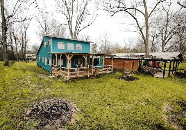 rear view of house featuring a lawn