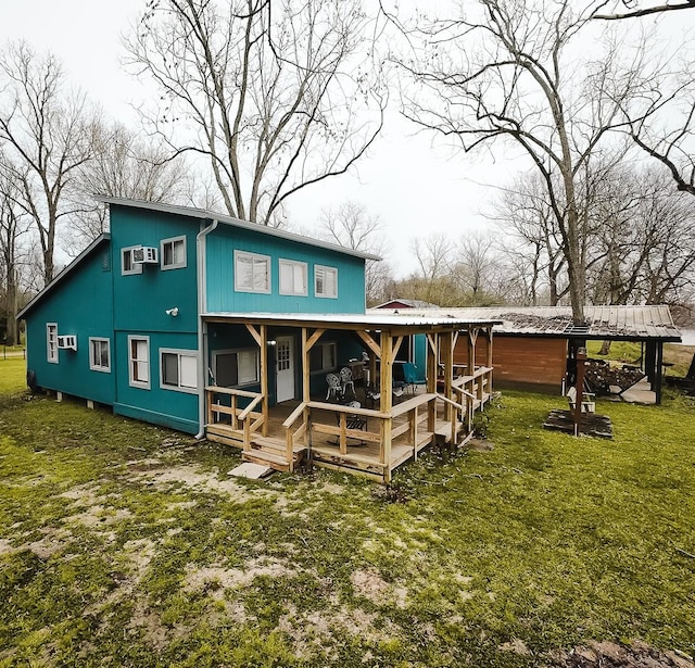 rear view of property with an AC wall unit and a yard