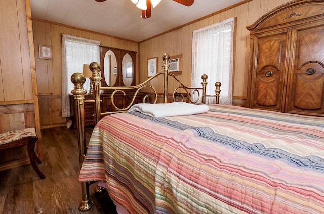 bedroom with wood walls, wood finished floors, a ceiling fan, and ornamental molding