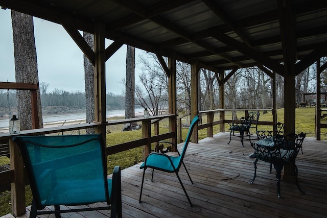 wooden deck featuring a yard and a water view