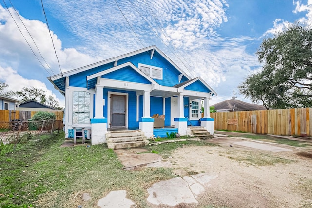 bungalow-style home featuring fence and covered porch