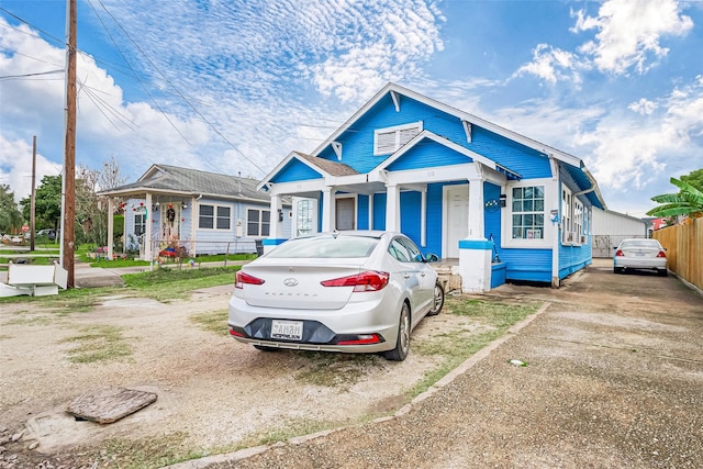 bungalow-style house with fence