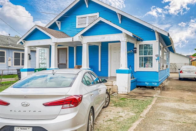 view of front of home featuring fence