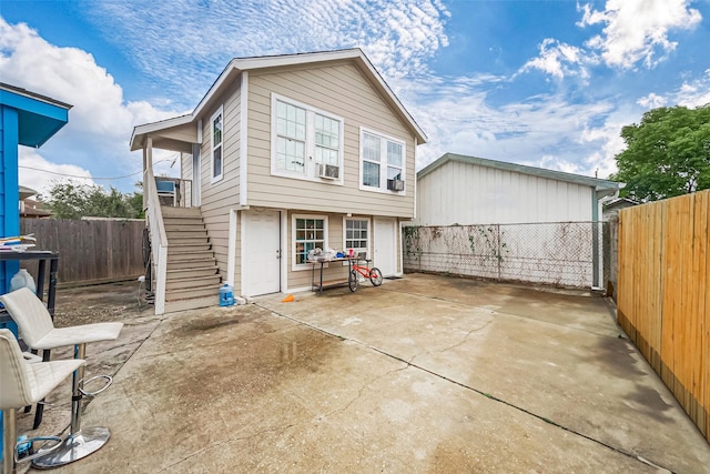 rear view of property with a patio area, cooling unit, stairs, and a fenced backyard