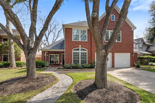 view of front of home with a garage, brick siding, and concrete driveway