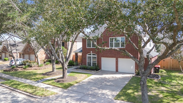 view of front facade with driveway, fence, a front yard, a garage, and brick siding