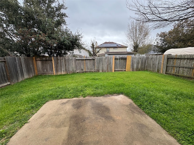 view of yard featuring a patio and a fenced backyard