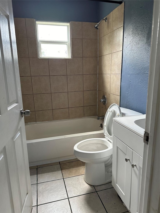 bathroom featuring vanity, shower / tub combination, toilet, a textured wall, and tile patterned floors