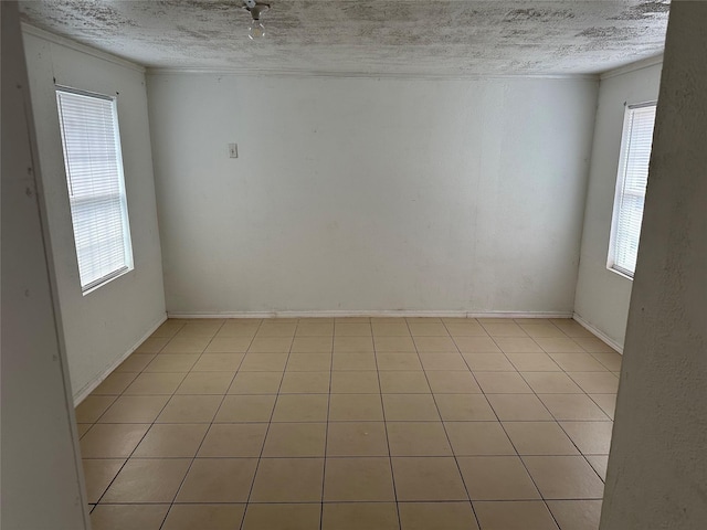 unfurnished room with a textured ceiling