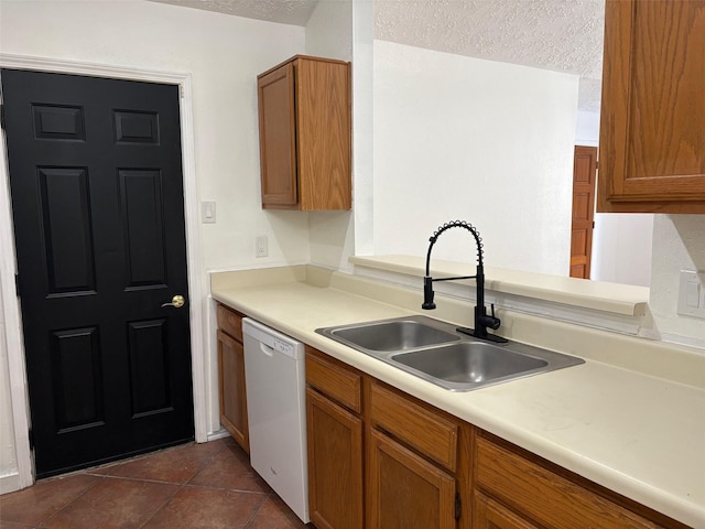 kitchen with a sink, a textured ceiling, dishwasher, and brown cabinetry