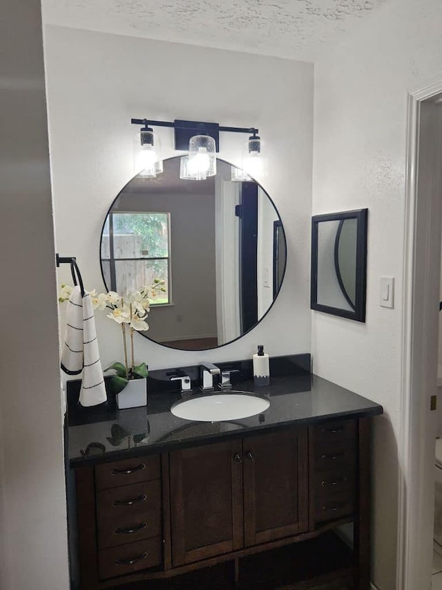 bathroom with vanity and a textured ceiling