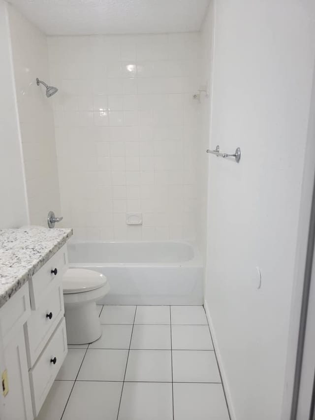 full bathroom featuring vanity, baseboards, tile patterned flooring, toilet, and shower / bathtub combination