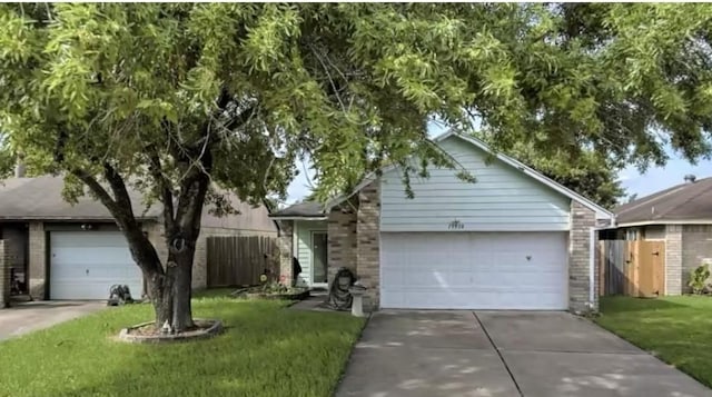 single story home featuring concrete driveway, an attached garage, fence, and brick siding