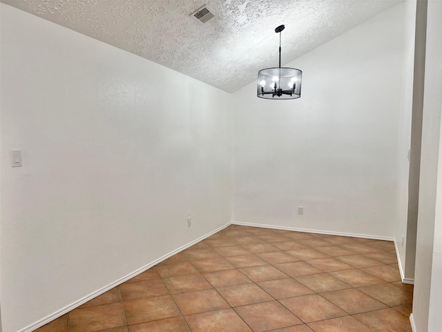 unfurnished room with baseboards, visible vents, lofted ceiling, a textured ceiling, and a chandelier