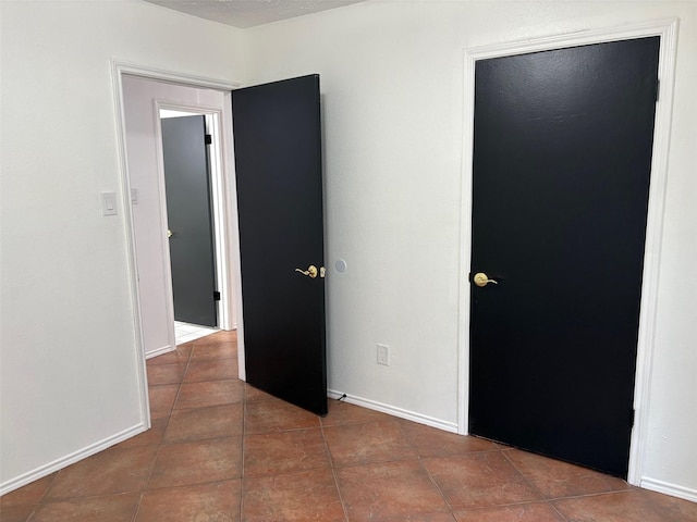 tiled spare room with baseboards