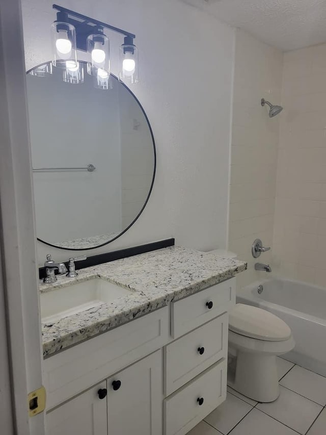 bathroom with vanity, a textured ceiling, bathing tub / shower combination, toilet, and tile patterned floors