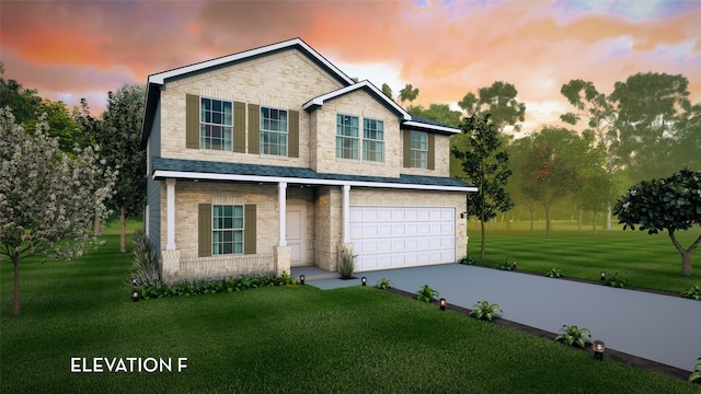 view of front facade with driveway, brick siding, an attached garage, and a front yard