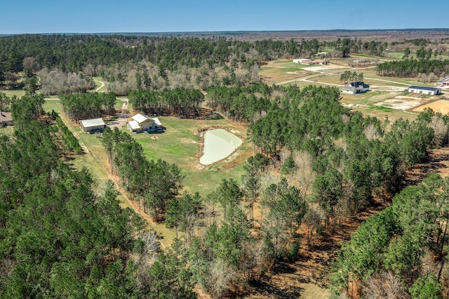 birds eye view of property with a wooded view