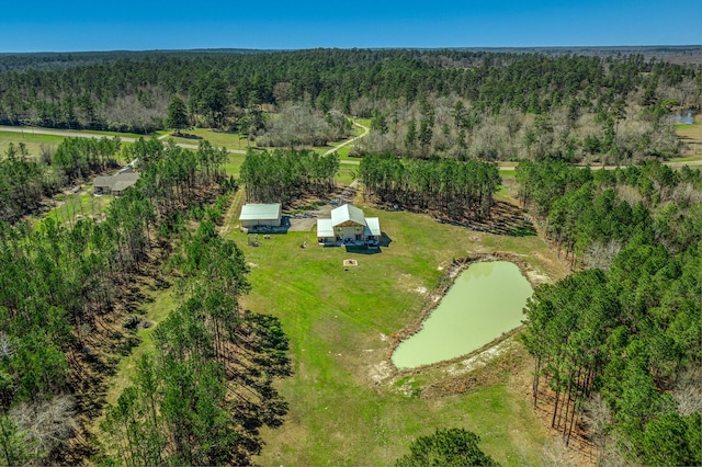 bird's eye view with a wooded view