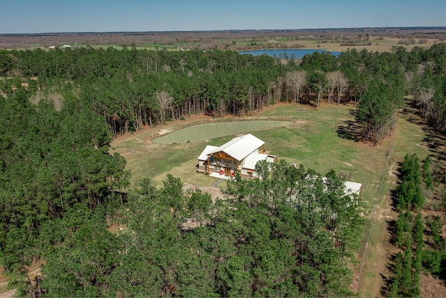 birds eye view of property with a forest view and a water view