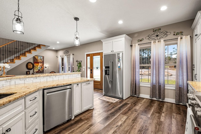 kitchen featuring light stone countertops, dark wood-style floors, recessed lighting, white cabinets, and appliances with stainless steel finishes