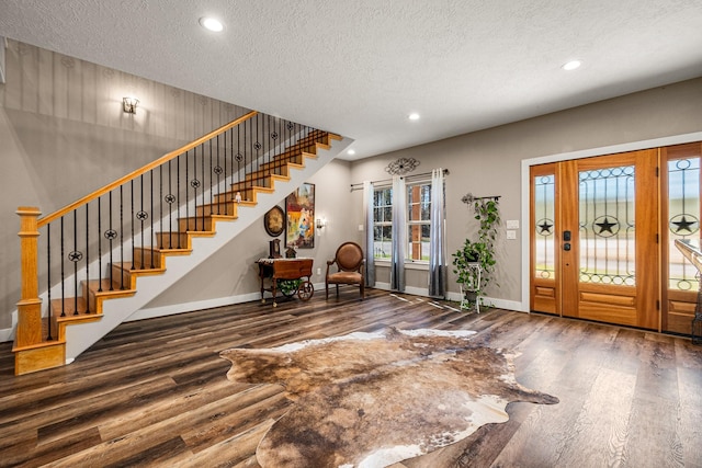 entryway featuring recessed lighting, stairs, baseboards, and wood finished floors